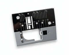A metal needle plate for a Janome sewing machine, displaying measurement markings and a guide for needle placement.