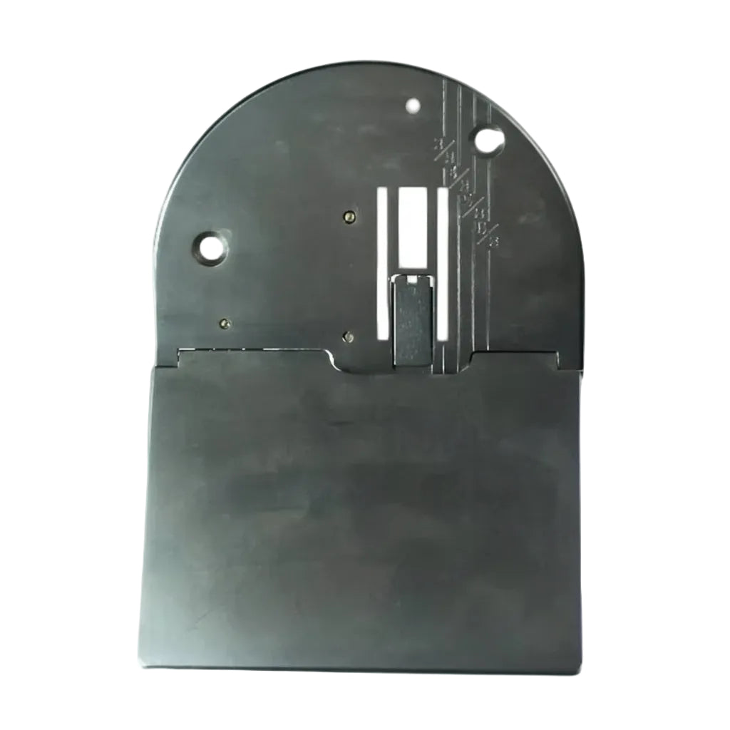 A black metal needle plate for a Janome sewing machine.