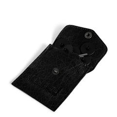 Black textured wallet with buttons on a white background