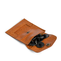 Brown leather pouch with buttons on a white background