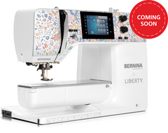 A BERNINA B 580 sewing machine with a white body, floral patterned upper housing, and a digital touchscreen display, shown on a solid green background with a red 'COMING SOON' badge in the top right corner.