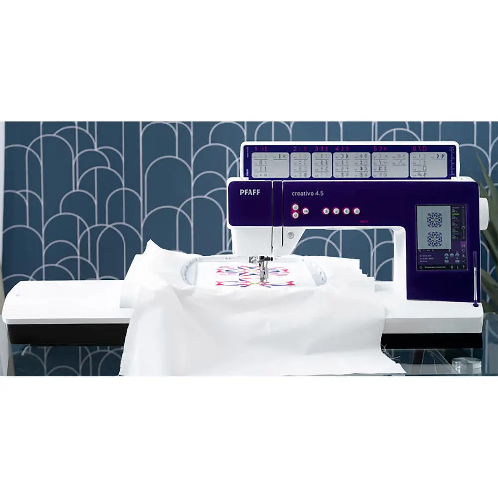 Embroidery machine with a blue geometric patterned wall in the background