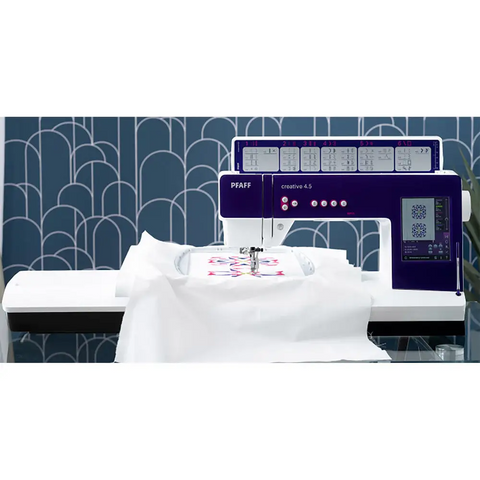 Embroidery machine with a blue geometric patterned wall in the background