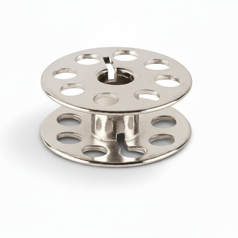 Two metal spools on a white background