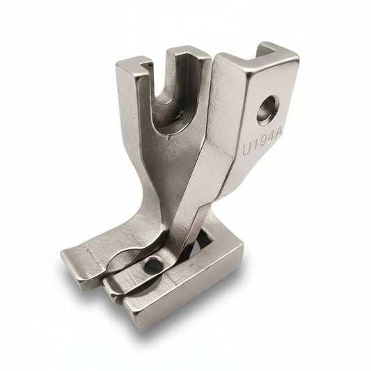 Metal sewing machine foot on a white background