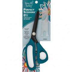 Pair of scissors with a colorful packaging design on a blue background